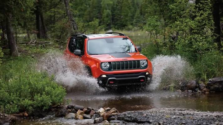 Jeep Renegade splashing through the wild