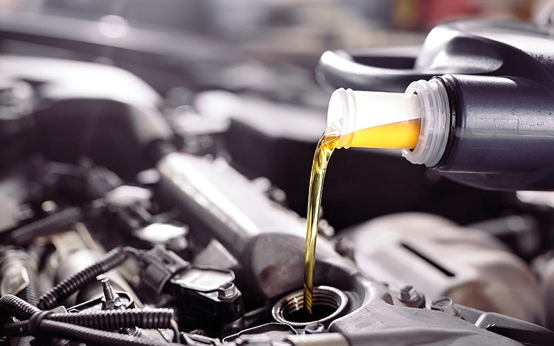 Pouring oil into engine for smooth performance