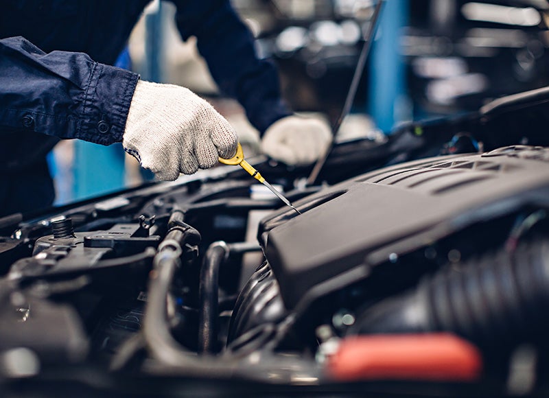 Technician servicing a car Engine